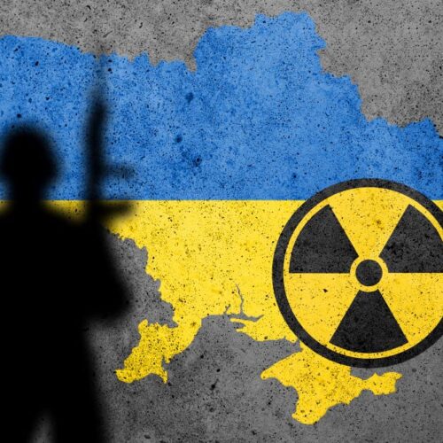 Flag map of Ukraine painted on a concrete wall with Zaporizhzhia Nuclear Power Plant